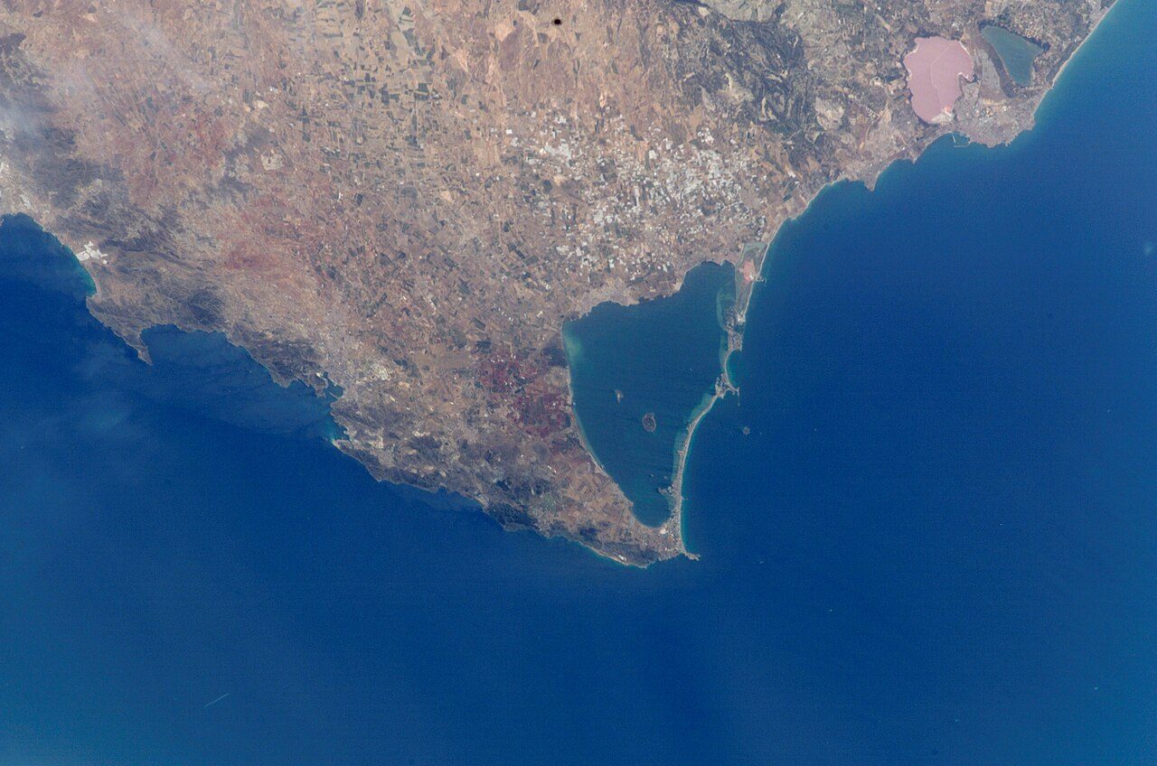 Foto de satélite de una laguna costera separada del mar por una estrecha franja de arena urbanizada