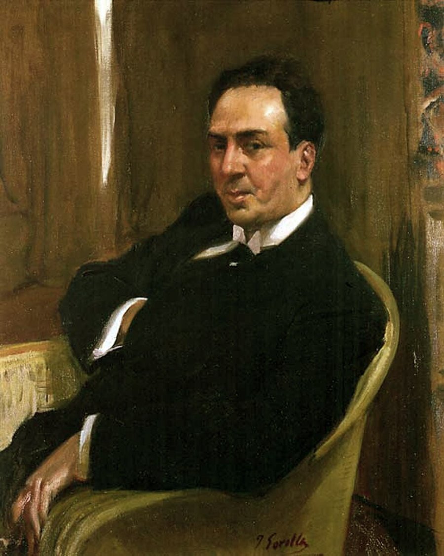 Retrato al óleo de Antonio Machado sentado en un sillón, con traje oscuro y camisa blanca